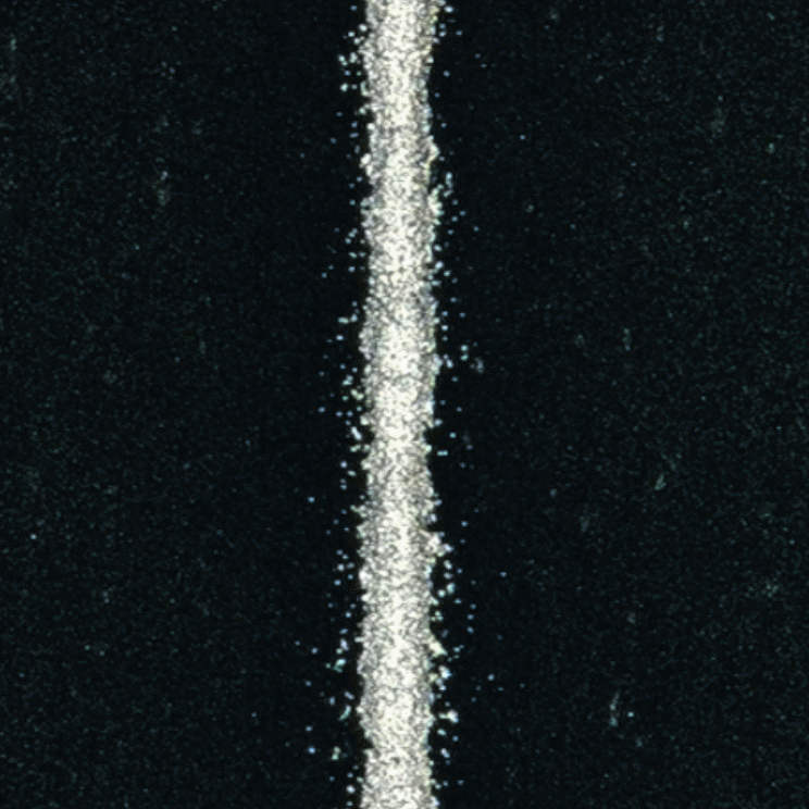 A top view of a silver line that has been screen printed onto a black background.